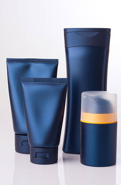 Blank cosmetic tube and bottle on white