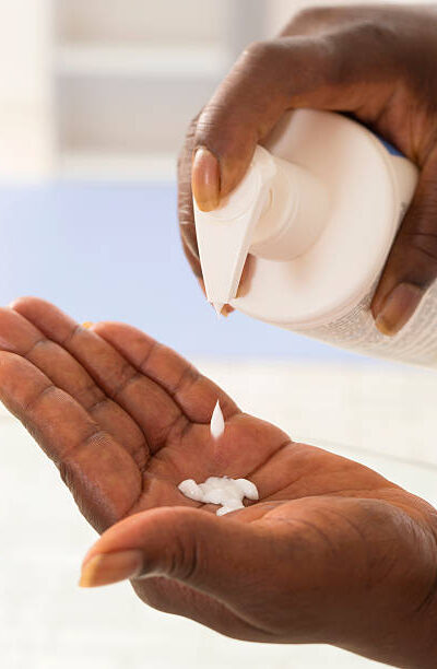 Pouring moisturizer into hand